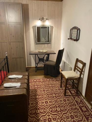 a living room with a table and a chair at Ypsus House Stemnitsa in Stemnitsa