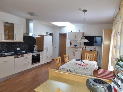 a kitchen with a table and a dining room at Ferienwohnung Anita in Sankt Gallenkirch