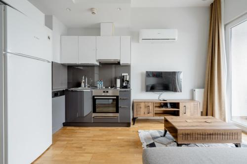 a kitchen with stainless steel appliances and a table at Seba Suites with Fitness And Pool in Istanbul