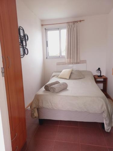 1 dormitorio con 1 cama con 2 toallas en Bluetres B&B, en Balneario Buenos Aires