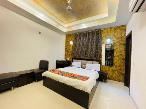 a bedroom with a bed and a desk and a chair at Hotel Taj Star by Urban stay in Agra
