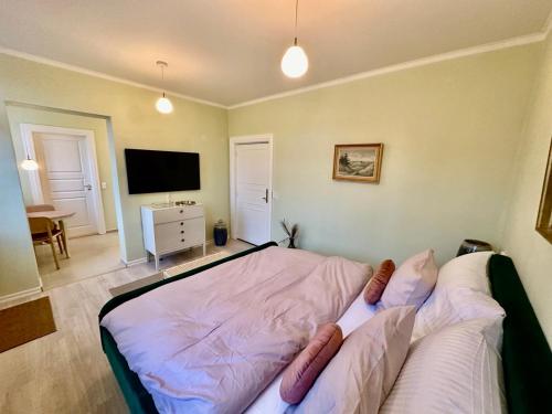 a bedroom with a bed with pillows on it at Hirtshals Gamle Station in Hirtshals