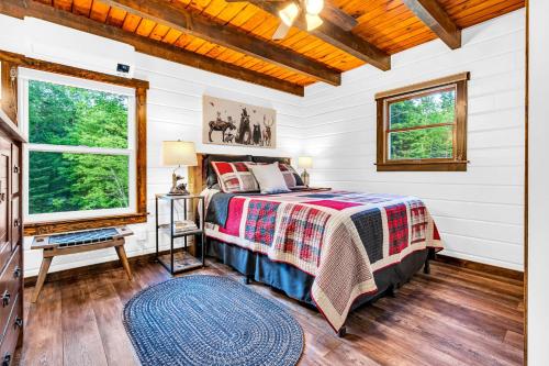 a bedroom with a bed and a window at Loon Lodge in Readfield