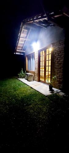 a small house at night with a light on it at Chalé Quinta Garden in Nova Friburgo