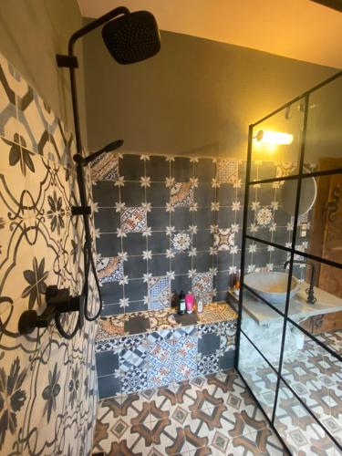 a bathroom with a shower with a toilet and tiles at Magical suite in a historical rectory house 
