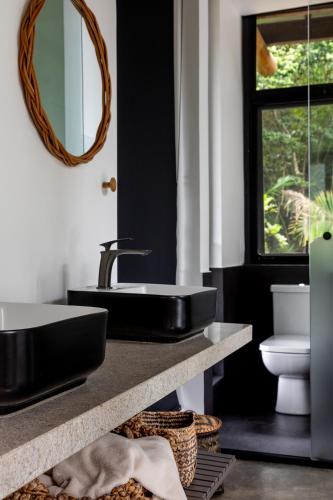 a bathroom with a black sink and a mirror at Casa Ocean in Ubatuba