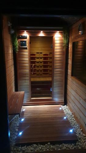 a wooden sauna with a wooden bench and lights at Lake house 21 relax accommodation iR Sauna in Warmond