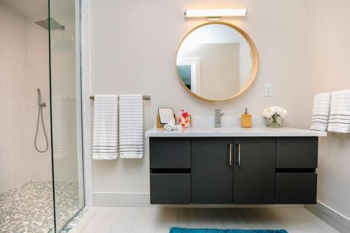 a bathroom with a sink and a mirror at Seahorse Cottage - Pool Home in Naples