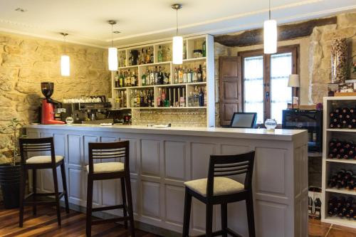 a bar with four stools in a wine cellar at Casona del Nansa in Herrerias