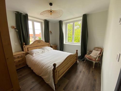 une chambre avec un grand lit et une fenêtre dans l'établissement Au clos du seltzbach, à Hoffen