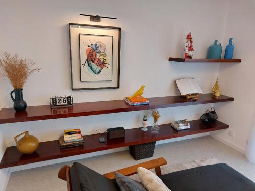 a living room with wooden shelves on the wall at Mostarda Boutique Apartment in Vila do Conde
