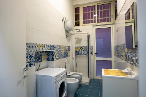 a bathroom with a sink and a washing machine at Seaview in Salerno