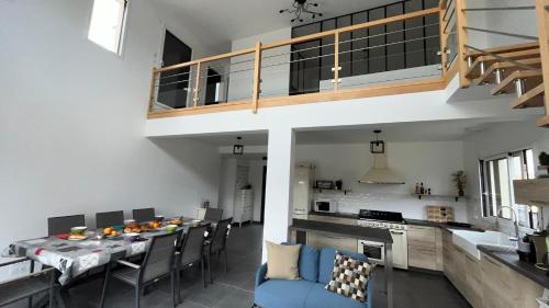 une cuisine et une salle à manger avec une table et des chaises dans l'établissement Au gré des oiseaux, à Beaugency