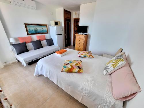 a living room with two beds and a couch at Estudio Las Naciones Bellavista in Benalmádena