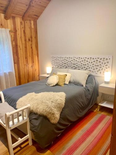 a bedroom with a large bed with a rug at La Carlina Casa de Montaña in San Carlos de Bariloche