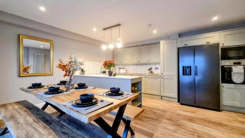 a kitchen with a wooden table and a blue refrigerator at The 4-Bed Brighton Escape in Brighton & Hove