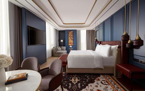 a bedroom with a bed and a living room at InterContinental Tashkent by IHG in Tashkent