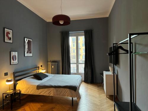 a bedroom with a bed and a window at La Madama Cristina in Turin