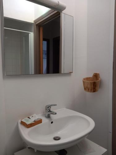 a bathroom with a white sink and a mirror at THALASSA in Audresselles