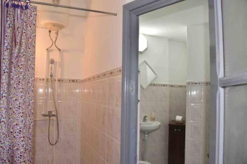 uma casa de banho com um chuveiro, um WC e um lavatório. em joli studio à louer em Meknès