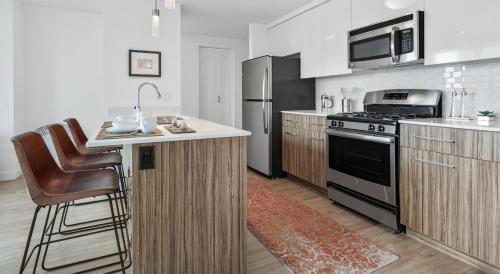 a kitchen with a sink and a stove top oven at NVCLL Chicago in Chicago