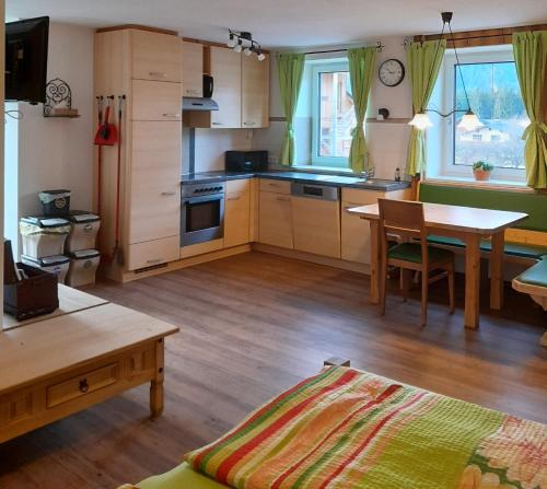 a kitchen with a table and a dining room at Appartement Berndlhof Mitterberg - Gröbming - Schladming in Gersdorf