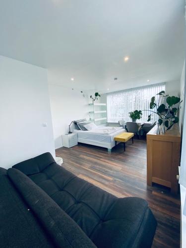 a living room with a bed and a couch at Easy Stay in Keflavík