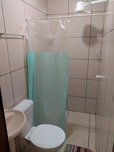 a bathroom with a shower with a toilet and a sink at Casa Com bilhar 4 quartos alter in Alter do Chao