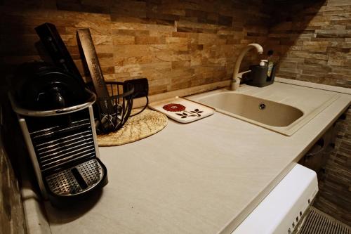 a kitchen counter top with a sink and a sink at Appartamento a due passi dal mare in Bordighera