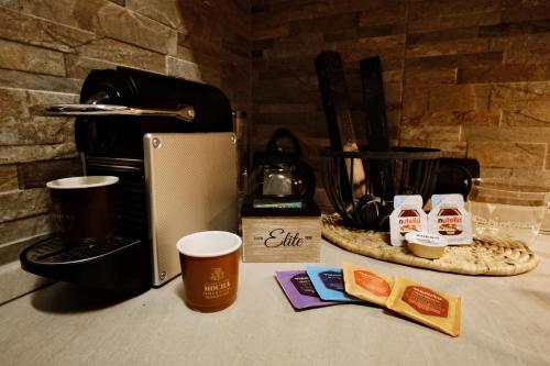 a counter top with a coffee maker and some food at Appartamento a due passi dal mare in Bordighera