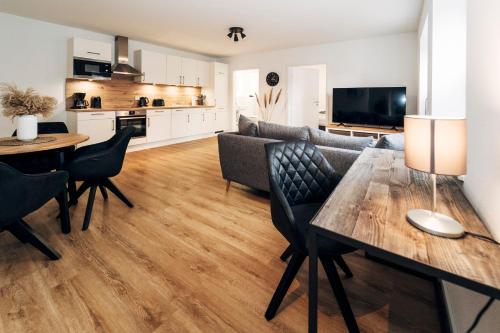 a kitchen and living room with a table and chairs at Tor zur Altstadt in Husum