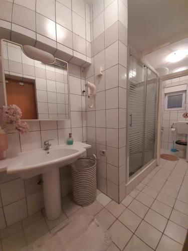 a bathroom with a sink and a shower at Pansion Ponte in Mostar
