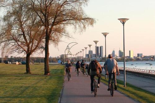 a group of people riding bikes down a sidewalk at Your city apartment. in Tallinn