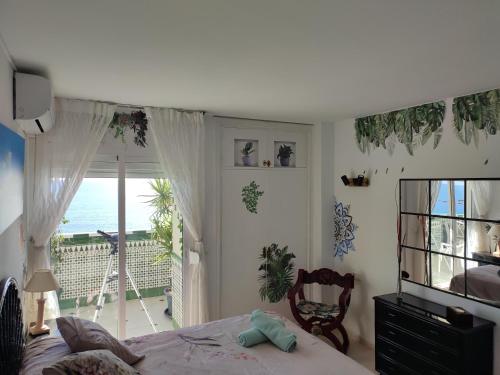 Schlafzimmer mit einem Bett und Meerblick in der Unterkunft Apartamento en playa semi-privada in Benalmádena