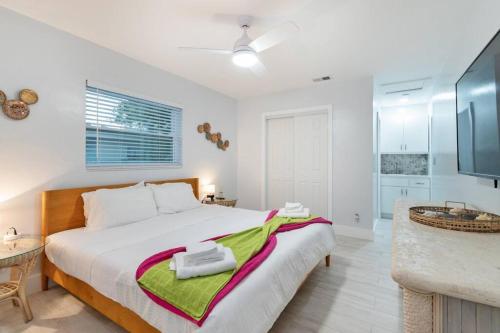 a bedroom with a large bed and a bathroom at Summer By The Sea 2 in Pompano Beach