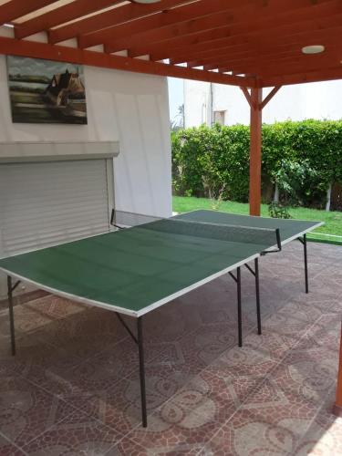 a ping pong table sitting on a patio at الريف الأروبي in Qaryat ash Shamālī