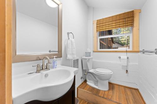 a bathroom with a white sink and a toilet at Hideaway in the Highlands - 4BR, Pet Friendly w Hot Tub - Minutes from the Lake & Tahoe City in Tahoe City