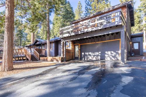 a house in the woods with a garage at Hideaway in the Highlands - 4BR, Pet Friendly w Hot Tub - Minutes from the Lake & Tahoe City in Tahoe City