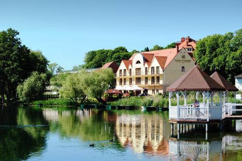 a lake with a house and a gazebo at Hotel Barlinek in Barlinek