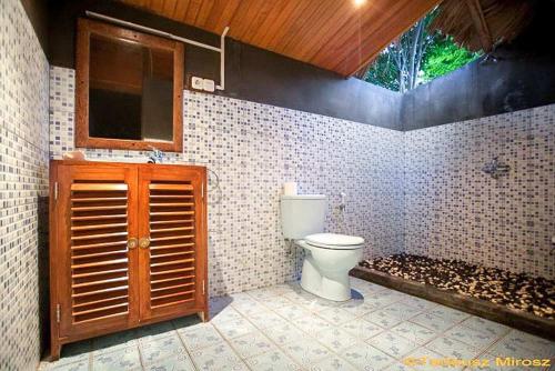 a bathroom with a toilet and a sink at Raja Laut Dive Resort Bunaken in Bunaken
