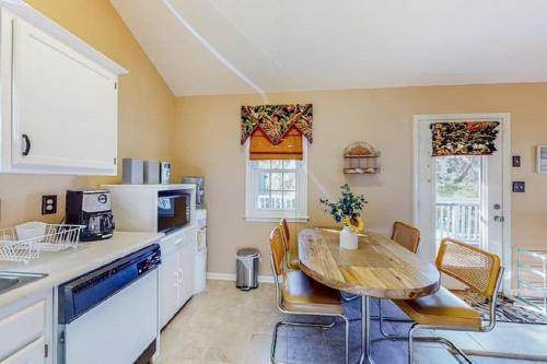 a kitchen with a table and a table and chairs at Ocean City Townhome by Beach Bayside in Ocean City