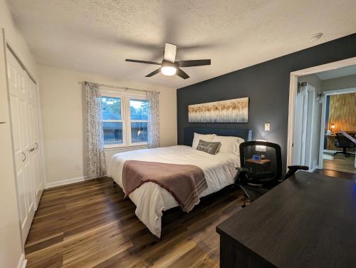 a bedroom with a bed and a ceiling fan at Modern Luxe Family & Groups Friendly Bungalow with Patio & Workspace in Marietta