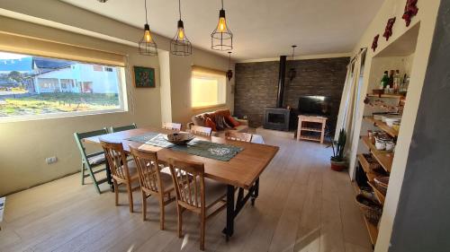 een eetkamer en een woonkamer met een tafel en stoelen bij CUNCUMEN Caviahue in Caviahue