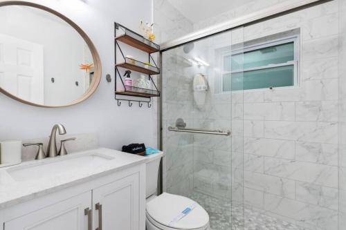a bathroom with a shower and a toilet and a sink at Summer By The Sea 1 in Pompano Beach