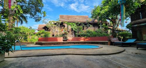 a swimming pool in front of a house at Club One Seven Gaymen Chiang Mai in Chiang Mai