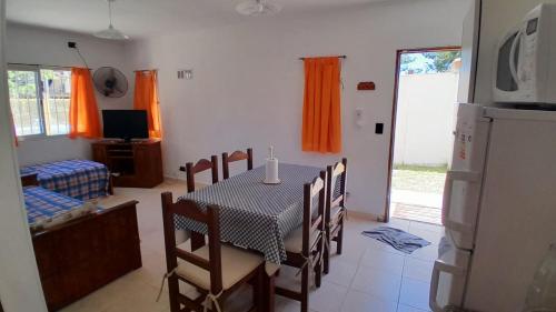 a kitchen and dining room with a table and chairs at Acutun in Mar de Ajó