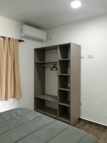 a bedroom with a bed and a book shelf at Complejo - LA ZULA - 1y2Dormitorios in Federación
