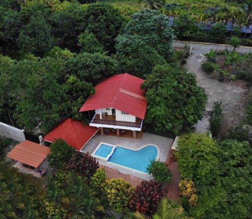 an overhead view of a house with a red roof at Nature villa Bonao in Bonao