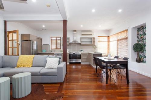 a living room with a couch and a table at Cosy Cottage Coolbellup in Spearwood