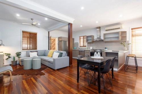 a living room with a couch and a table at Cosy Cottage Coolbellup in Spearwood